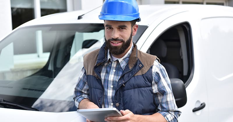 Man in front of van on tablet 